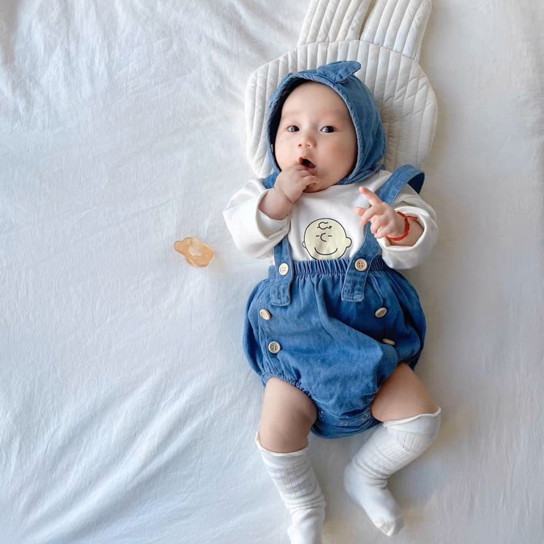 Baby wearing the Baby Charlie Brown cartoon-style romper