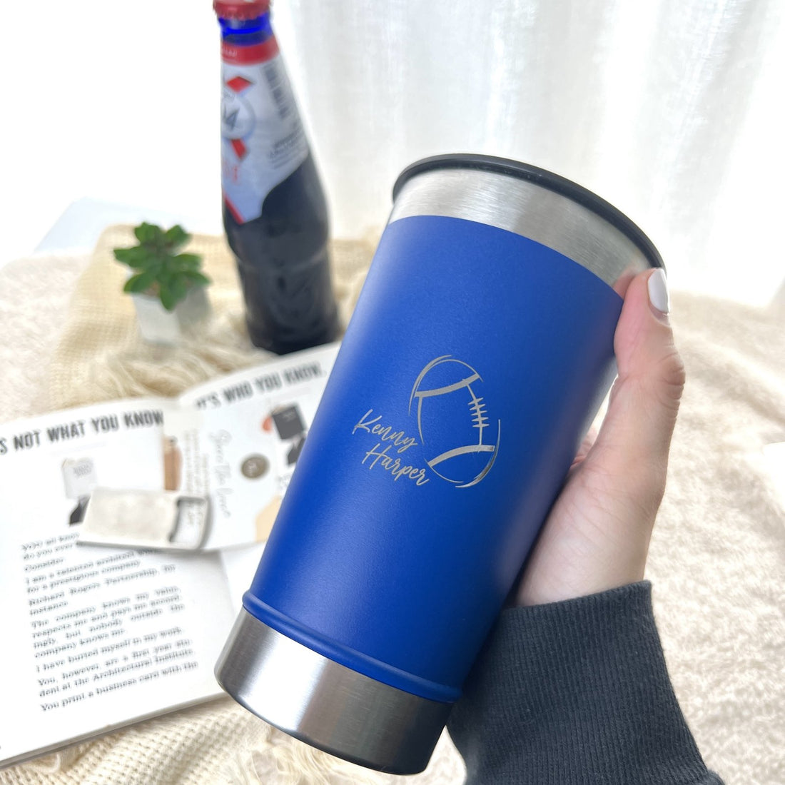 Personalised 480ml blue tumbler with engraved name, held in hand, By Glee