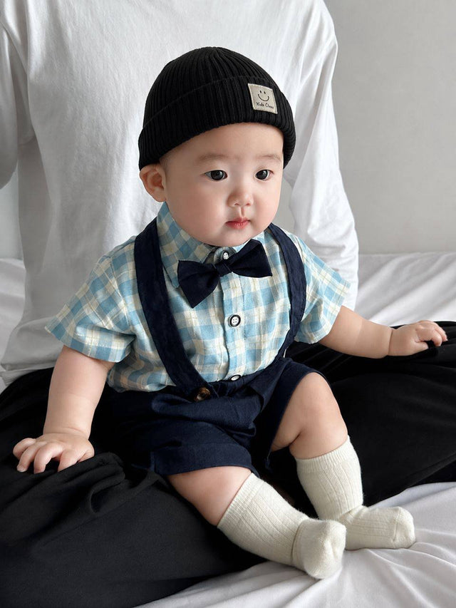 Baby wearing the Charlie Boy blue gingham shirt with bow tie and suspender shorts