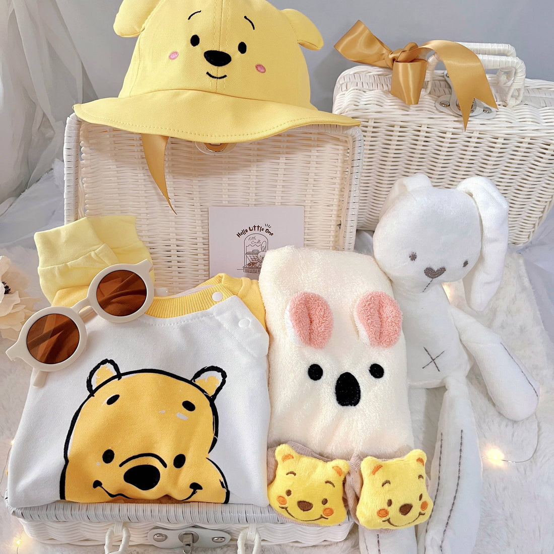 Honey Bunch premium baby gift set in a rattan basket with yellow honey-bear romper with hat and socks