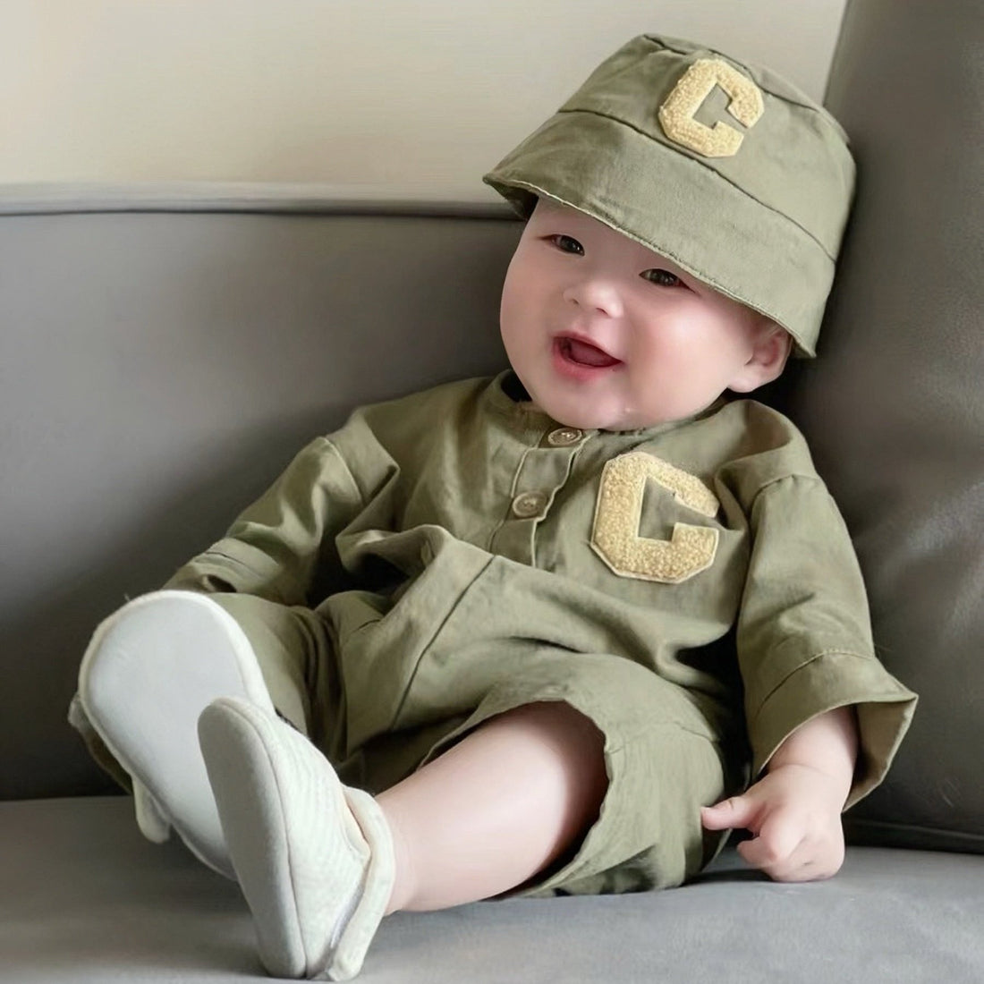 Baby wearing the Little Tiny Trooper army-green romper