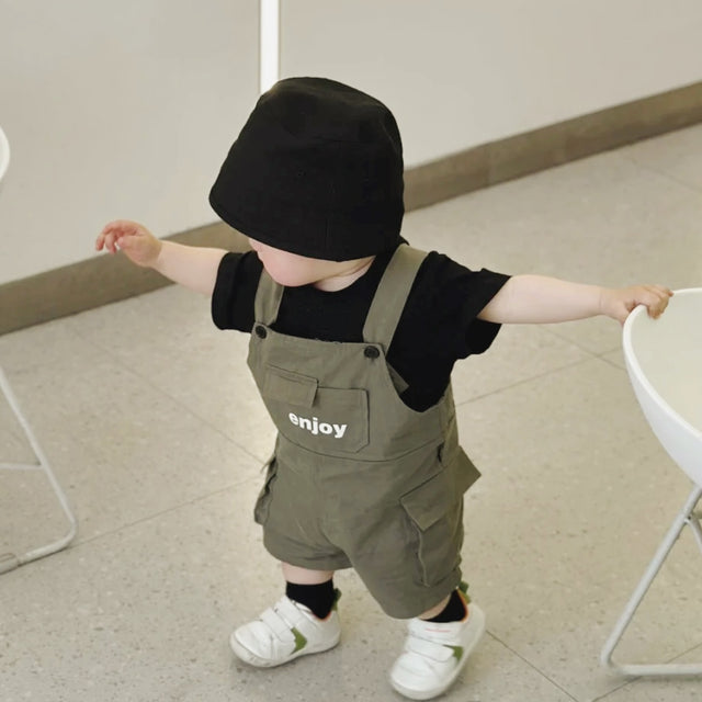 Baby wearing the Mini Militia Green black romper with green jacket and hat