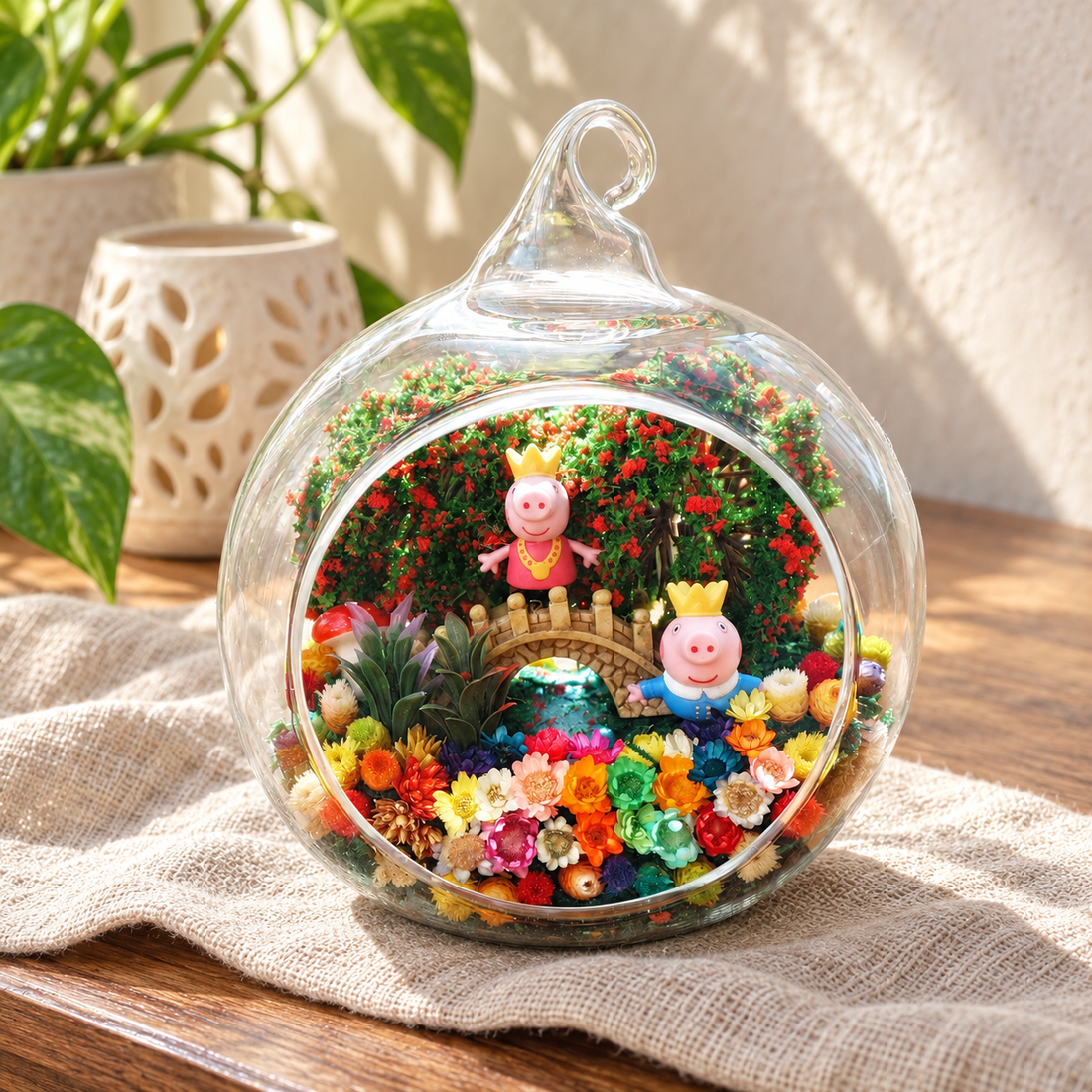 Pink Piglet Flower Terrarium styled in a natural home setting with clear glass and product details