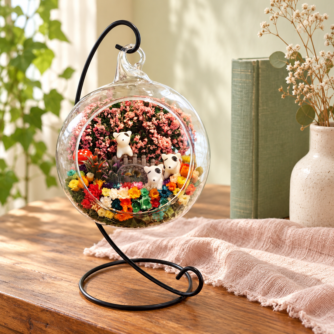 Three Puppies Preserved Flower Terrarium styled in a natural home setting with clear glass and product details