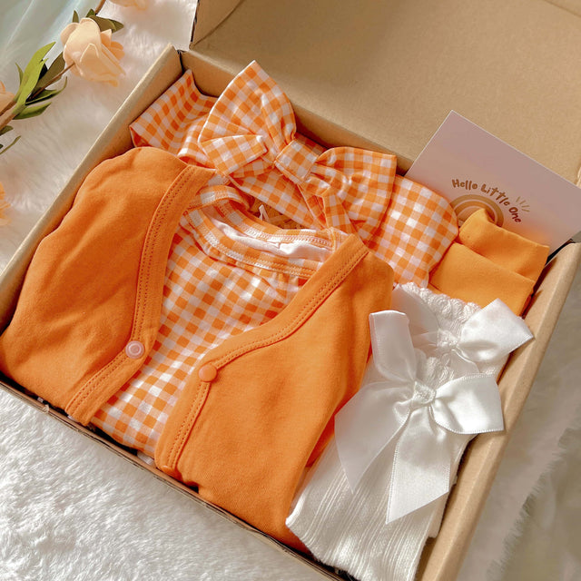 Orange Buttercup standard baby gift box with orange romper and cardigan