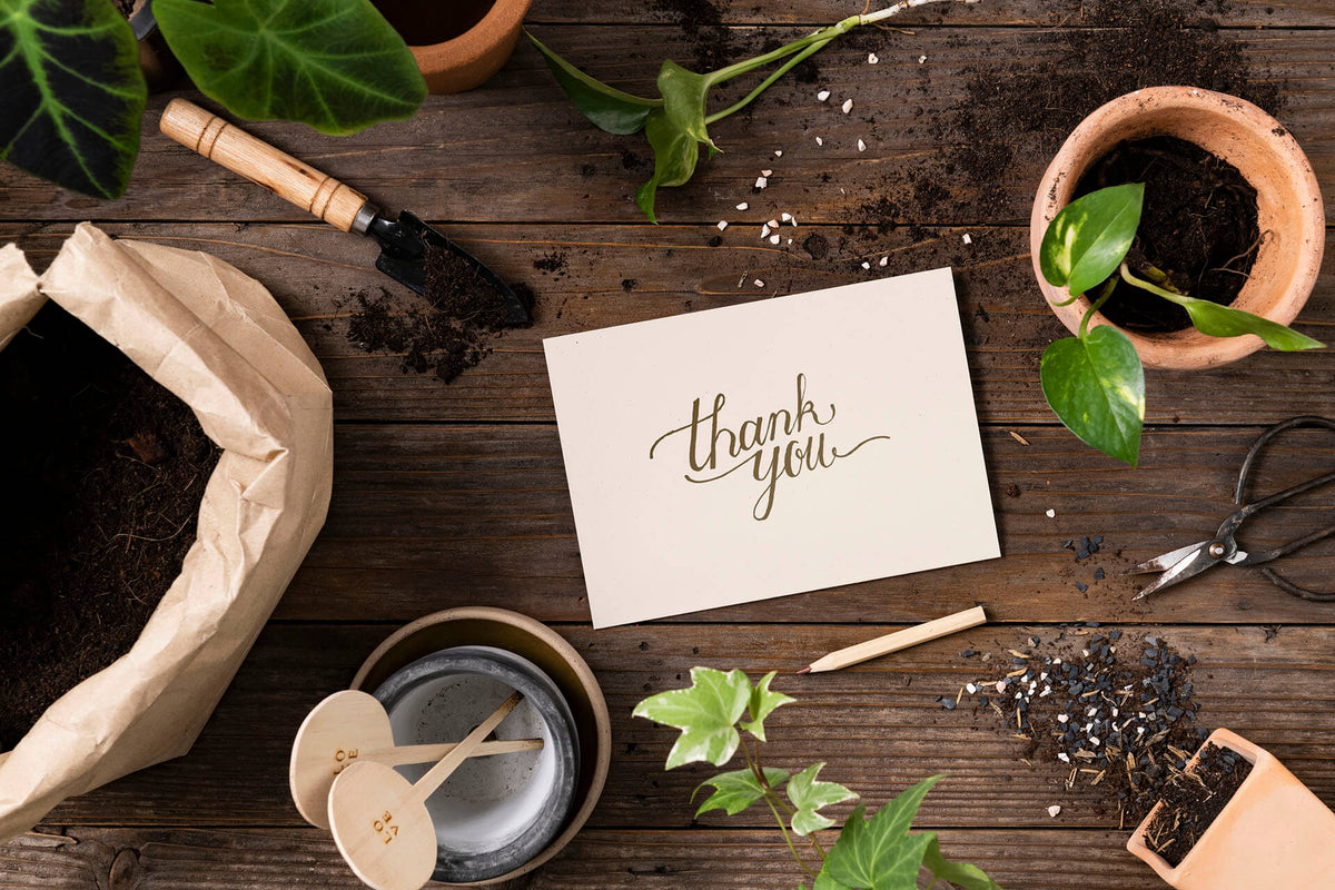 Handwritten thank-you card on a wooden table
