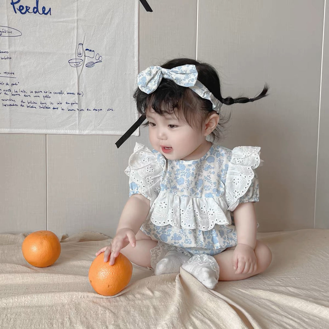 Baby wearing the Baby Blue Princess blue princess romper