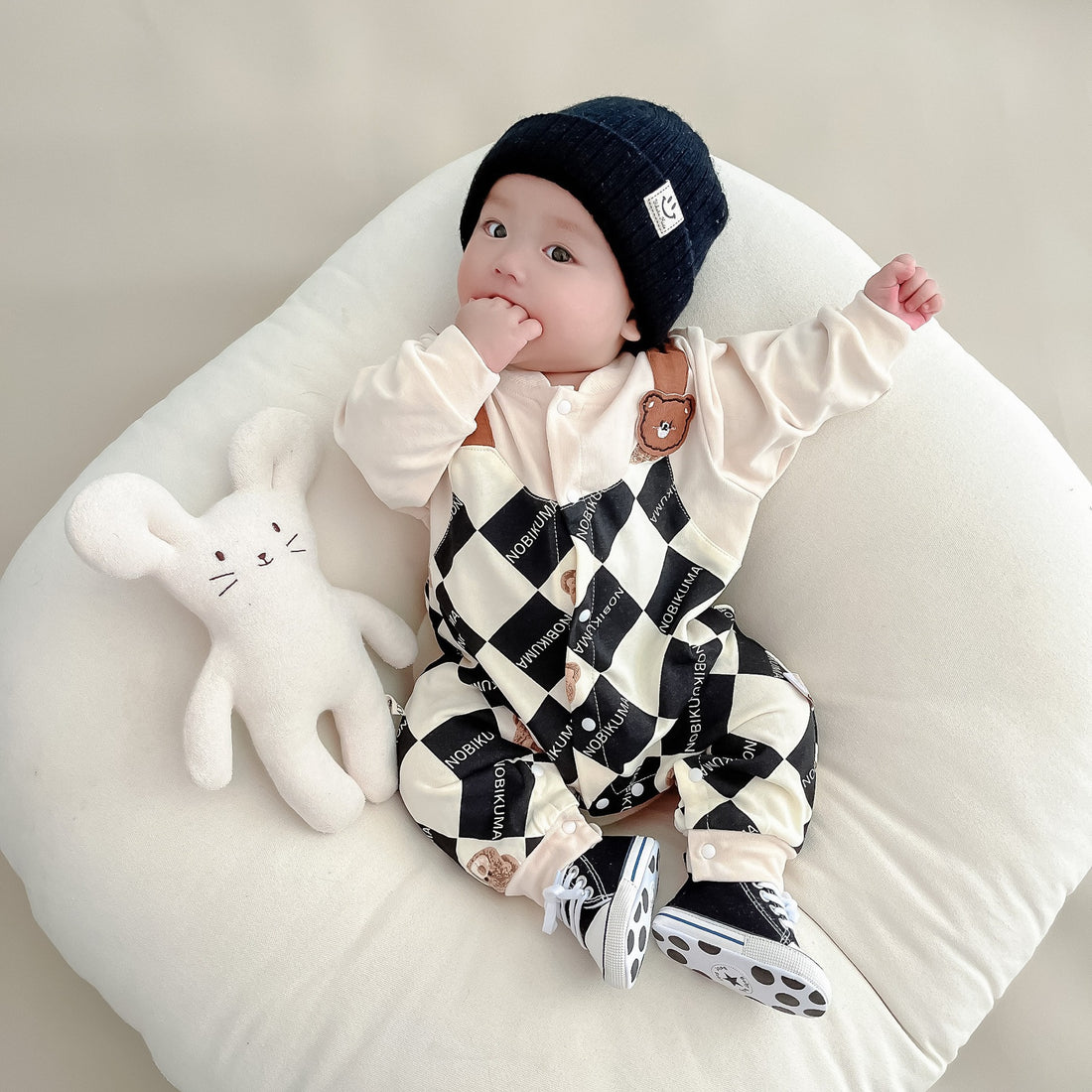 Baby wearing the Baby Checkmate checkered romper