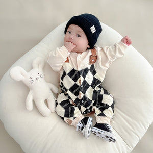 Baby wearing the Baby Checkmate checkered romper