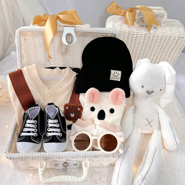 Baby Checkmate premium baby gift set in a rattan basket with checkered romper