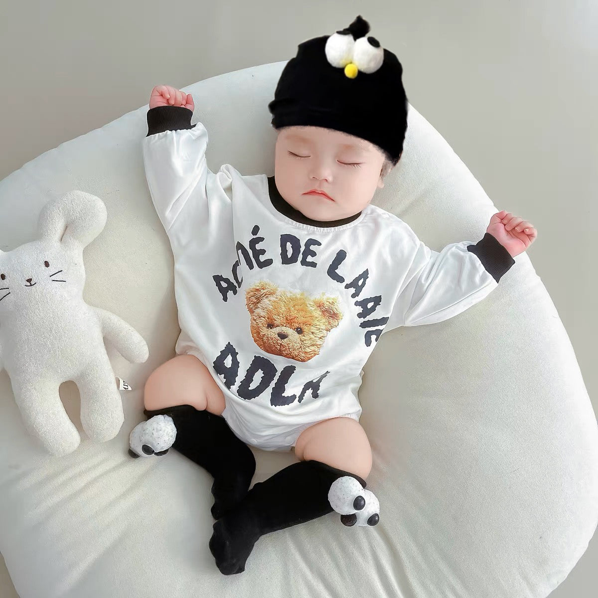 Baby wearing the Baby Streetstyle black-and-white streetwear romper