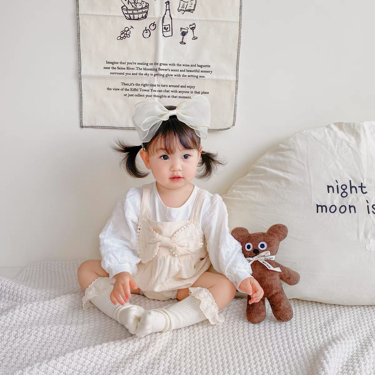 Baby wearing the Buttercream Angel cream long-sleeve romper