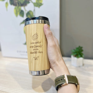 Personalised bamboo coffee mug 450ml with engraved cookie quote, held in hand, By Glee