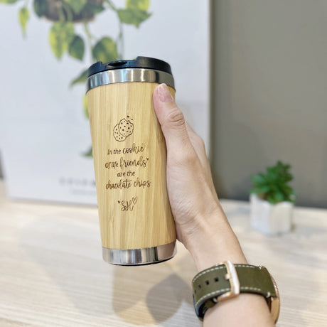 Personalised bamboo coffee mug 450ml with engraved cookie quote, held in hand, By Glee