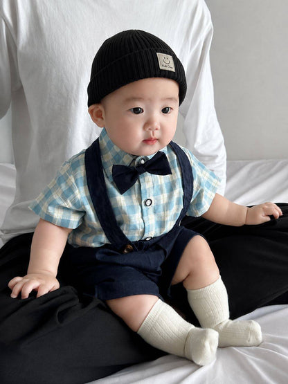 Baby wearing the Charlie Boy blue gingham shirt with bow tie and suspender shorts