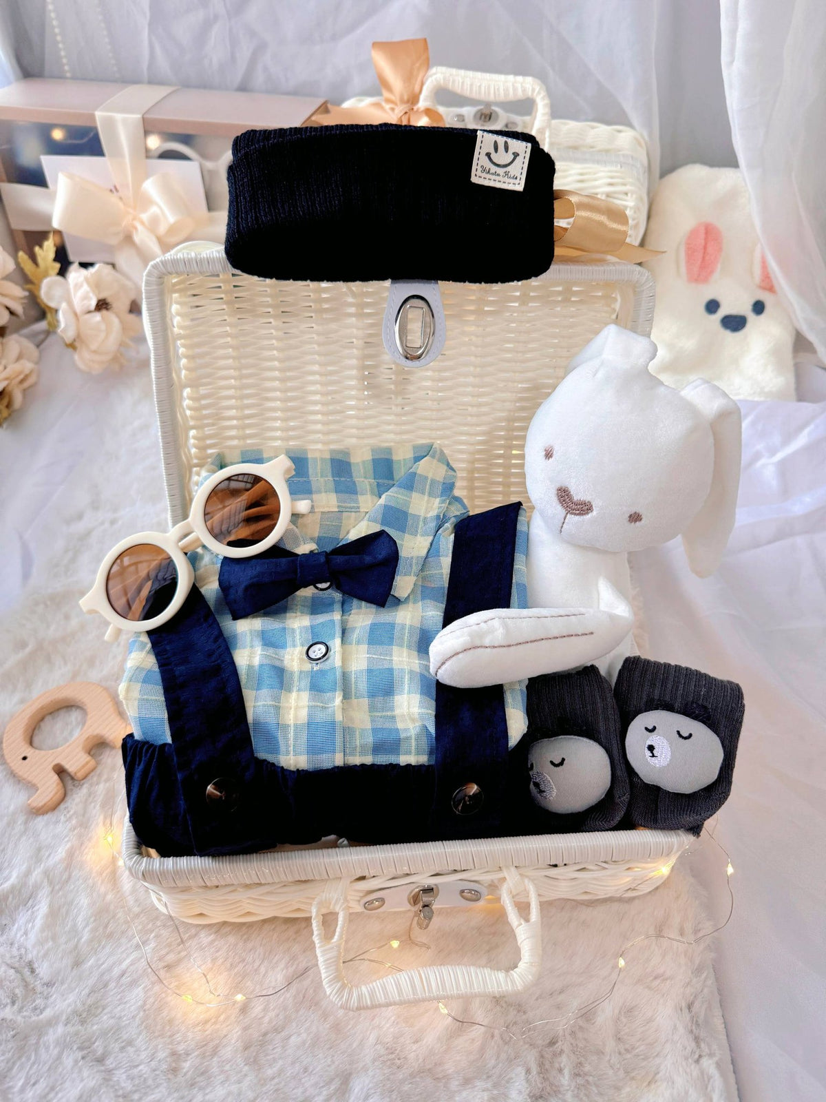 Charlie Boy premium baby gift set in a rattan basket with blue gingham shirt with bow tie and suspender shorts