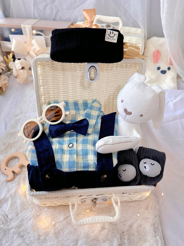 Charlie Boy premium baby gift set in a rattan basket with blue gingham shirt with bow tie and suspender shorts