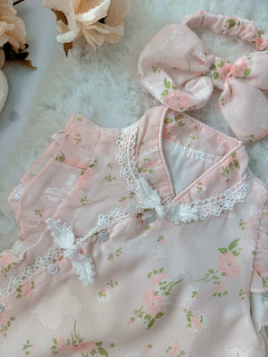 Cherry Blossom baby outfit flat lay – pink floral cheongsam-style romper with bow headband