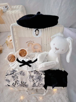 French Blossom premium baby gift set in a rattan basket with floral romper with ruffled collar and black beret