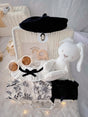 French Blossom premium baby gift set in a rattan basket with floral romper with ruffled collar and black beret
