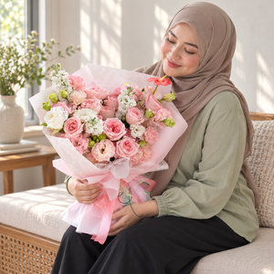 Élise Pink Rose, Stock & Eustoma Bouquet held by the same recipient in a seated candid pose.