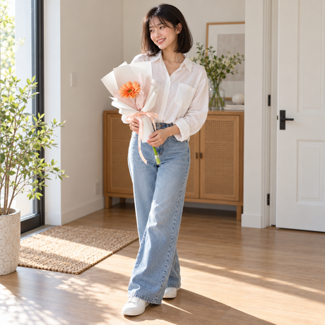 Single Gerbera Bloom held by the same recipient in a wider standing pose.