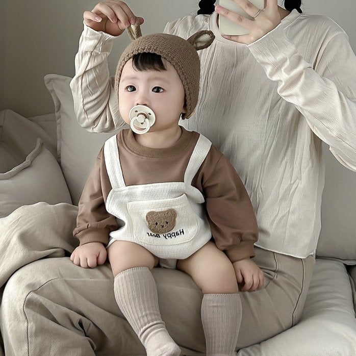 Baby wearing the Happy Bear bear overall romper with bear-ear knit hat