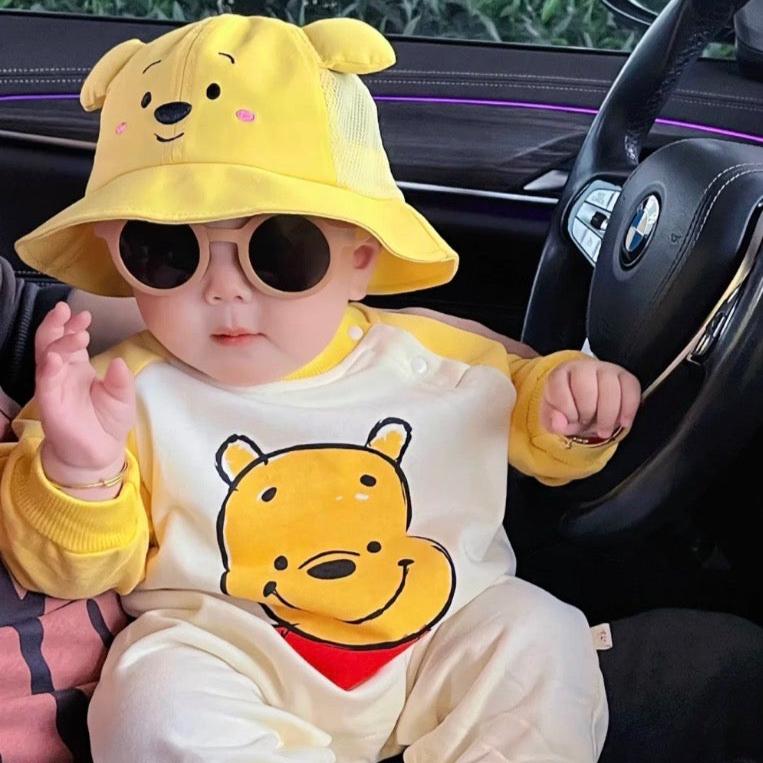 Baby wearing the Honey Bunch yellow honey-bear romper with hat and socks