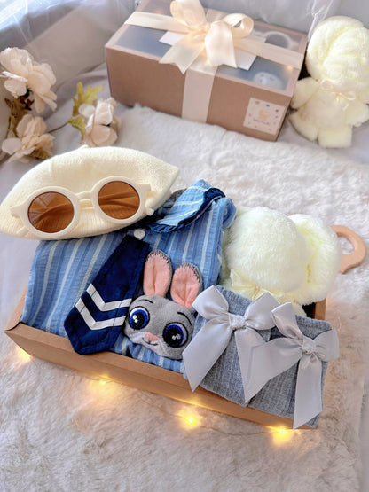 Judy Bunny classic baby gift box with blue striped romper with tie and bunny badge