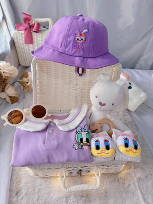 Little Daisy premium baby gift set in a rattan basket with lilac duck-collar romper with bucket hat