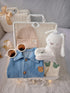 Little Denim Bear premium baby gift set in a rattan basket with denim romper with bear badge and knit beanie