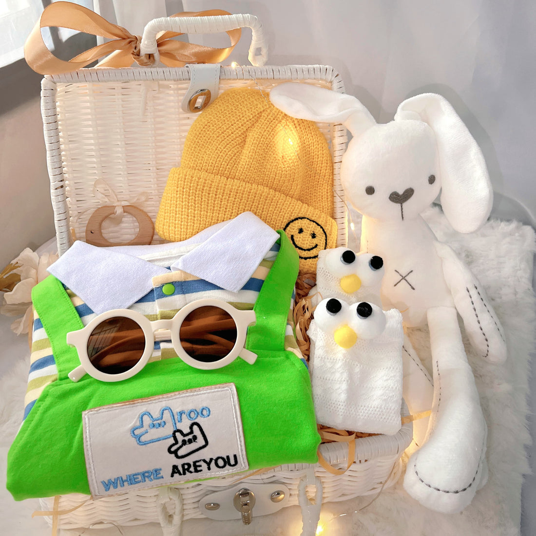 Little Green Sprout premium baby gift set in a rattan basket with green striped romper with yellow hat