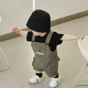 Baby wearing the Mini Militia Green black romper with green jacket and hat