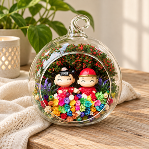 Couple in Traditional Hats Preserved Flower Terrarium styled in a natural home setting with clear glass and product details