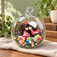 Forehead Kiss Couple Preserved Flower Terrarium styled in a natural home setting with clear glass and product details