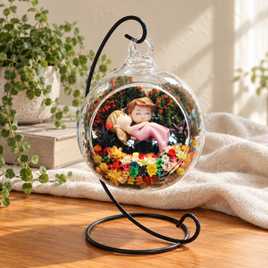 Hugging Couple Preserved Flower Terrarium styled in a natural home setting with clear glass and product details