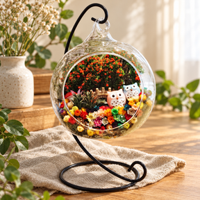 Pink and Blue Owls Preserved Flower Terrarium styled in a natural home setting with clear glass and product details