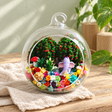 Purple Elephant Preserved Flower Terrarium styled in a natural home setting with clear glass and product details