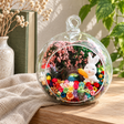 Rabbit with Carrot Preserved Flower Terrarium styled in a natural home setting with clear glass and product details