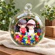 Sitting Couple with Heart Preserved Flower Terrarium styled in a natural home setting with clear glass and product details
