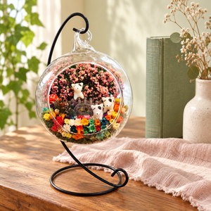Three Puppies Preserved Flower Terrarium styled in a natural home setting with clear glass and product details