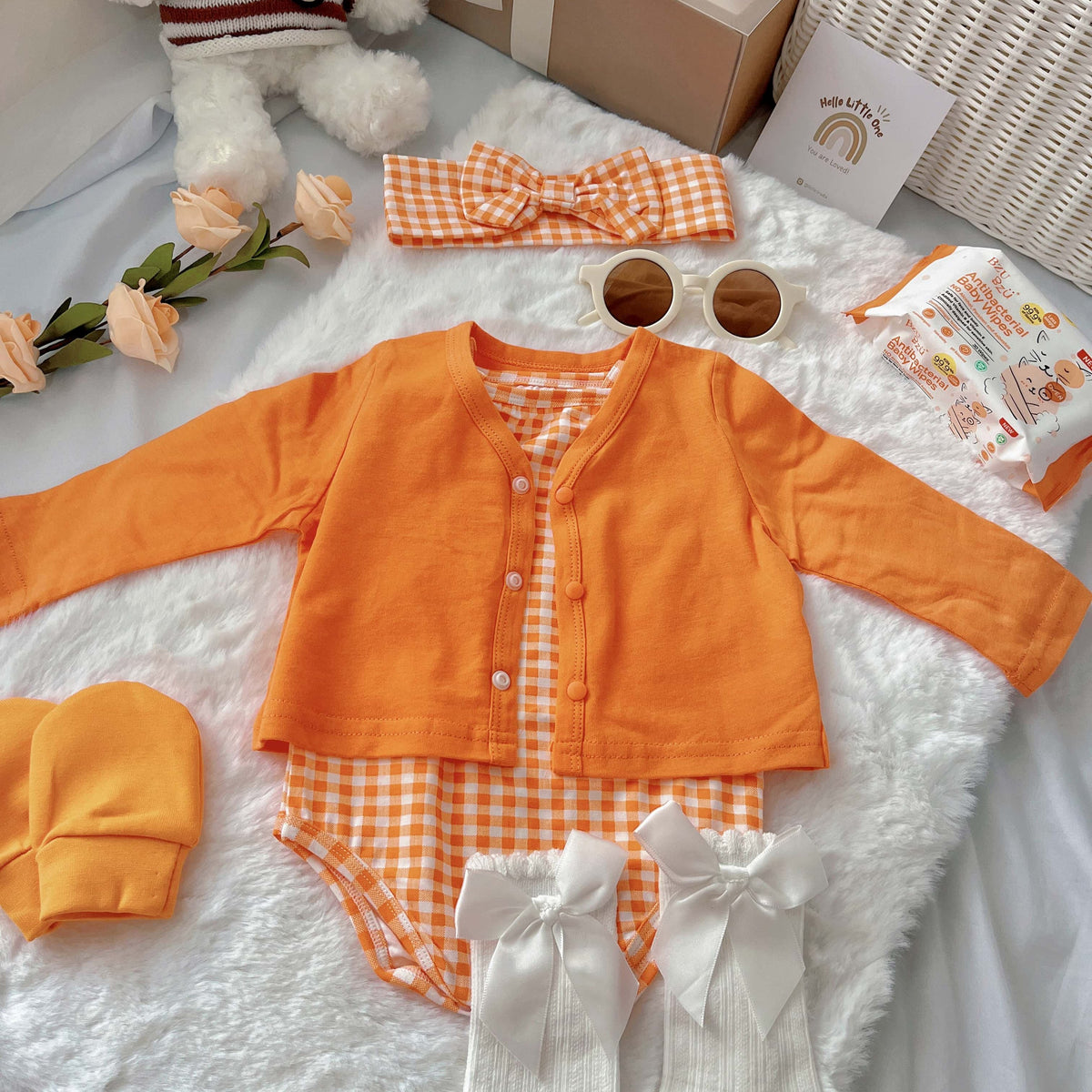 Orange Buttercup baby outfit styling – orange romper and cardigan