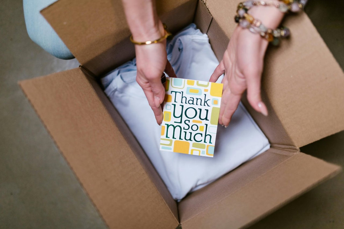Packing a gift box with a thank-you card