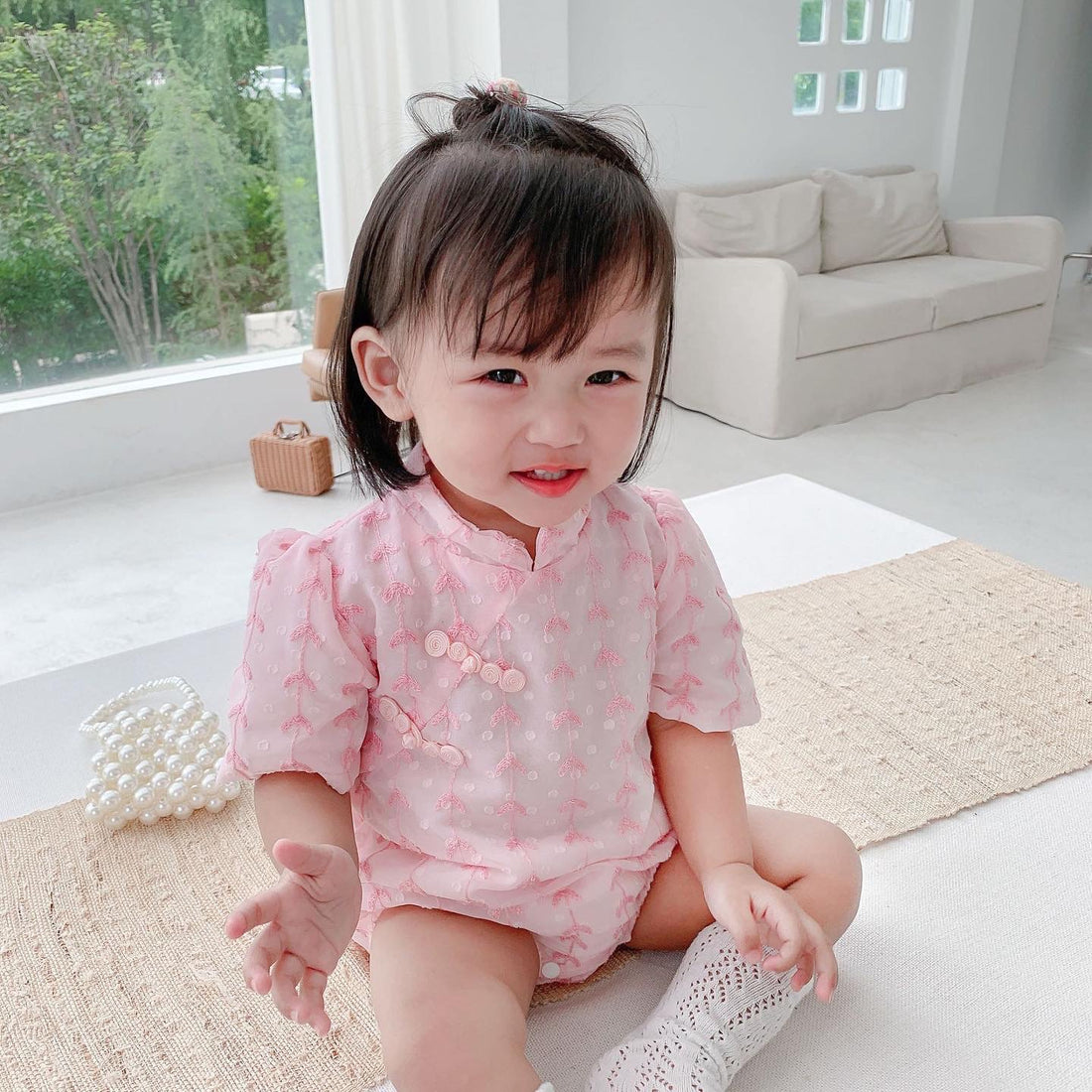 Baby wearing the Pink Cheongsam pink cheongsam-style romper