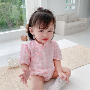 Baby wearing the Pink Cheongsam pink cheongsam-style romper