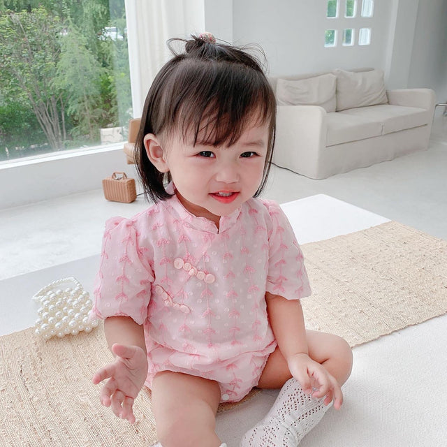 Baby wearing the Pink Cheongsam pink cheongsam-style romper