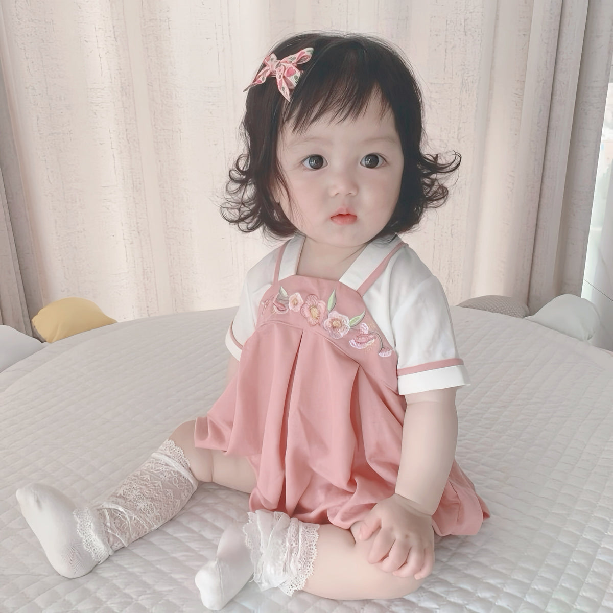 Baby wearing the Pink Hanbok pink Hanbok-style romper