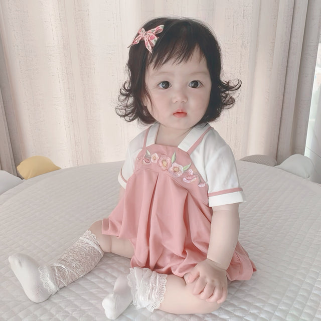 Baby wearing the Pink Hanbok pink Hanbok-style romper