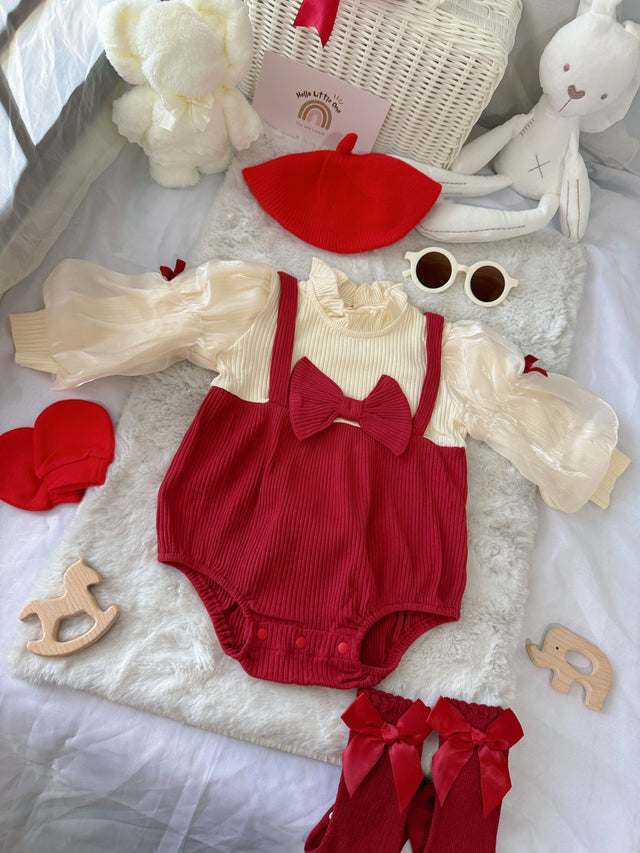 Red Riding Hood baby outfit flat lay – red romper with puff sleeves, bows and red beret