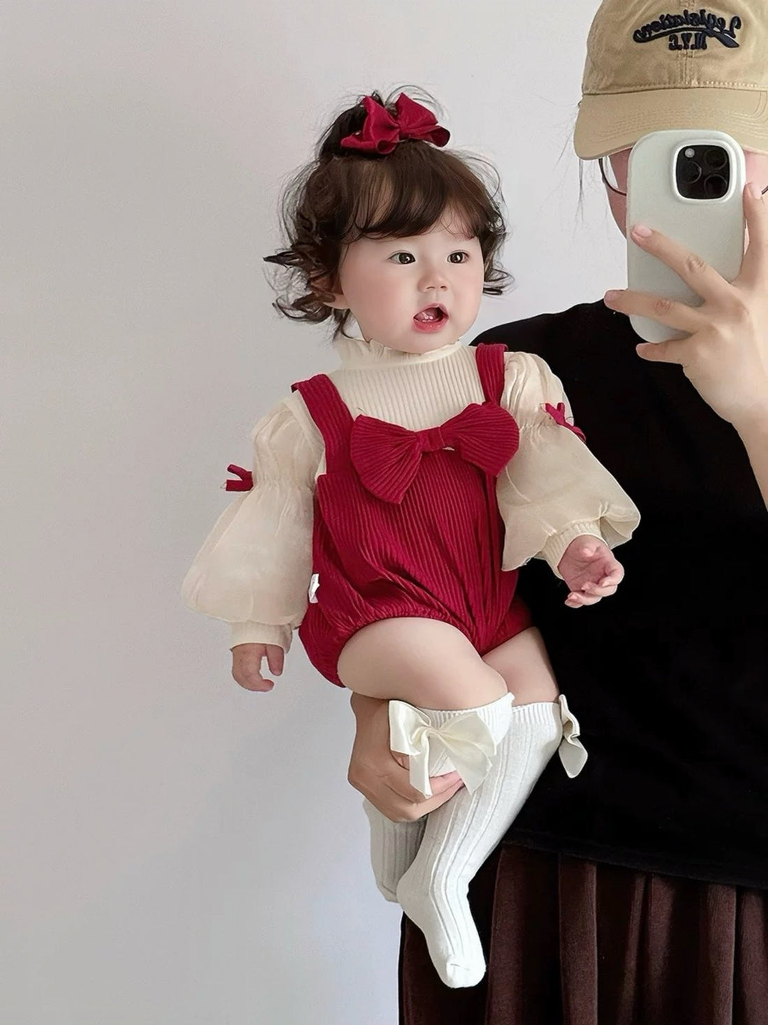 Baby wearing the Red Riding Hood red romper with puff sleeves, bows and red beret